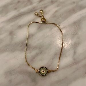 Elegant Gold Tone Evil Eye Bracelet with Intricate Crystal Design, Slide Closure